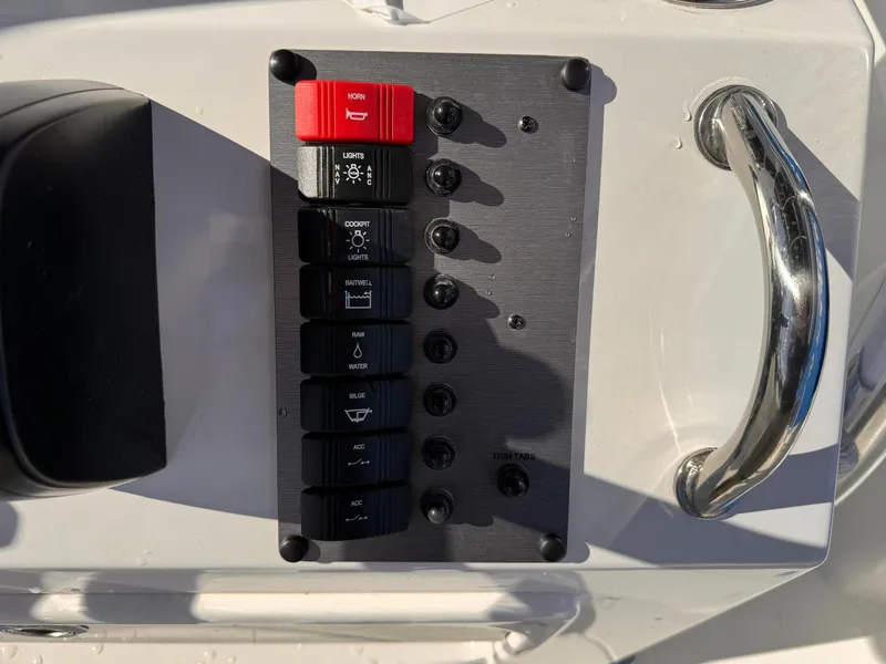 Slide: The Image of Control panel of 2025 Parker 18SE Center Console boat with switches and handle. - 24