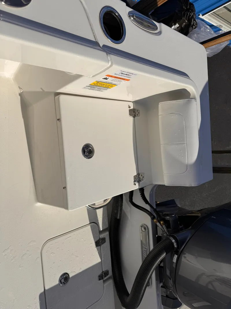Slide: The Image of 2025 Parker 18SE Center Console boat dashboard with storage compartment and controls. - 28