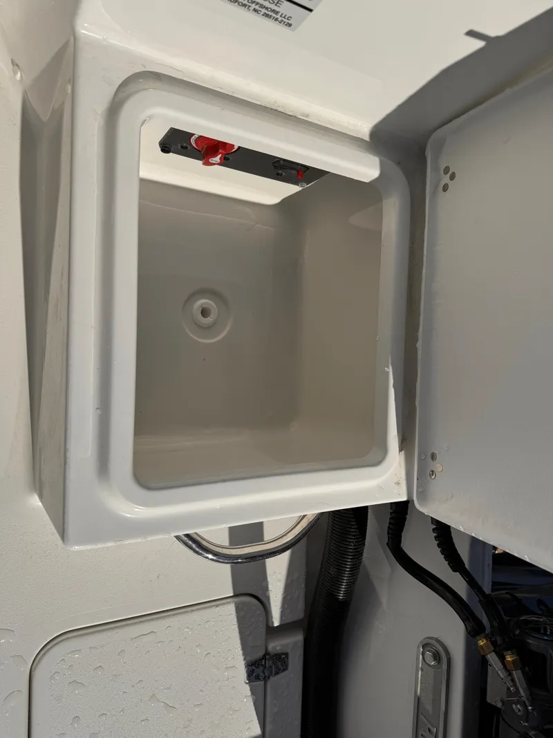 Slide: The Image of 2025 Parker 18SE Center Console storage compartment with open lid, showcasing interior space. - 29