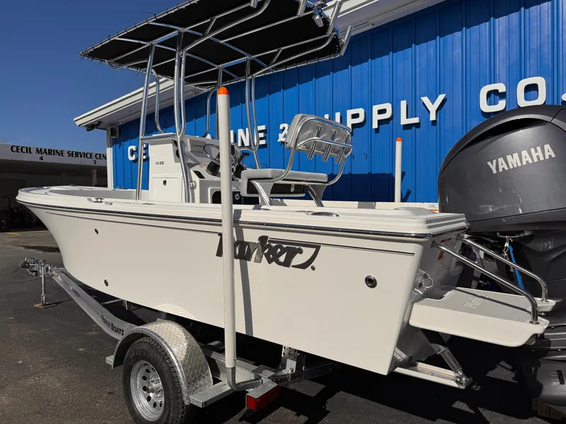 Slide: The Image of 2025 Parker 18SE Center Console boat on trailer, parked outside marine supply store. - 3