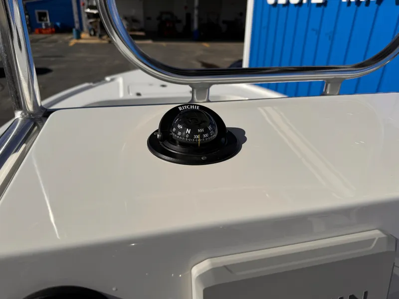 Slide: The Image of Compass on 2025 Parker 18SE Center Console boat dashboard, with blue building in background. - 34