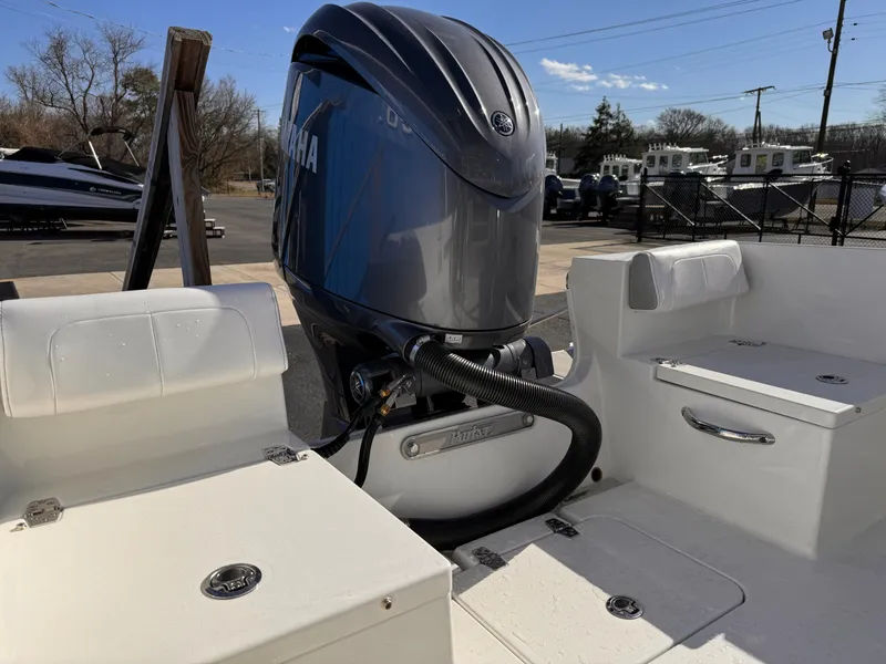 Slide: The Image of 2025 Parker 18SE Center Console boat with Yamaha outboard motor, docked outdoors. - 36
