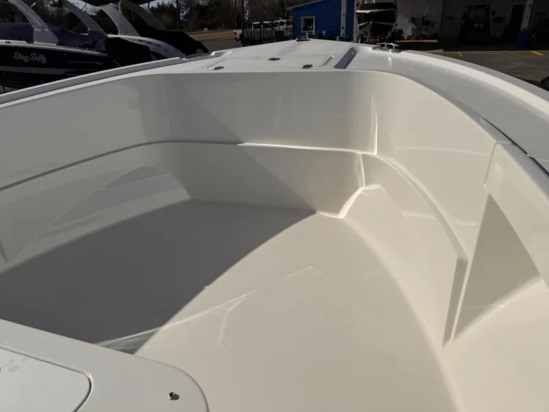 Slide: The Image of 2025 Parker 18SE Center Console boat interior, showcasing sleek white design and spacious seating area. - 39