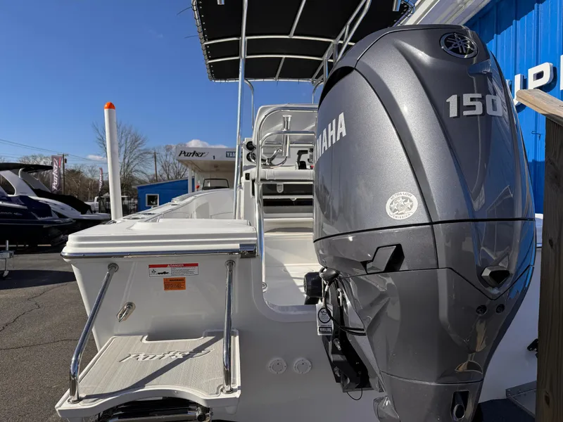 Slide: The Image of 2025 Parker 18SE Center Console boat with Yamaha 150 engine, docked outdoors. - 4