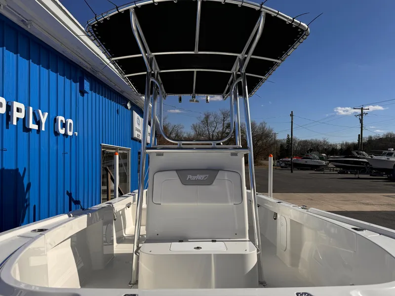 Slide: The Image of 2025 Parker 18SE Center Console boat with T-top, docked near a blue building. - 48