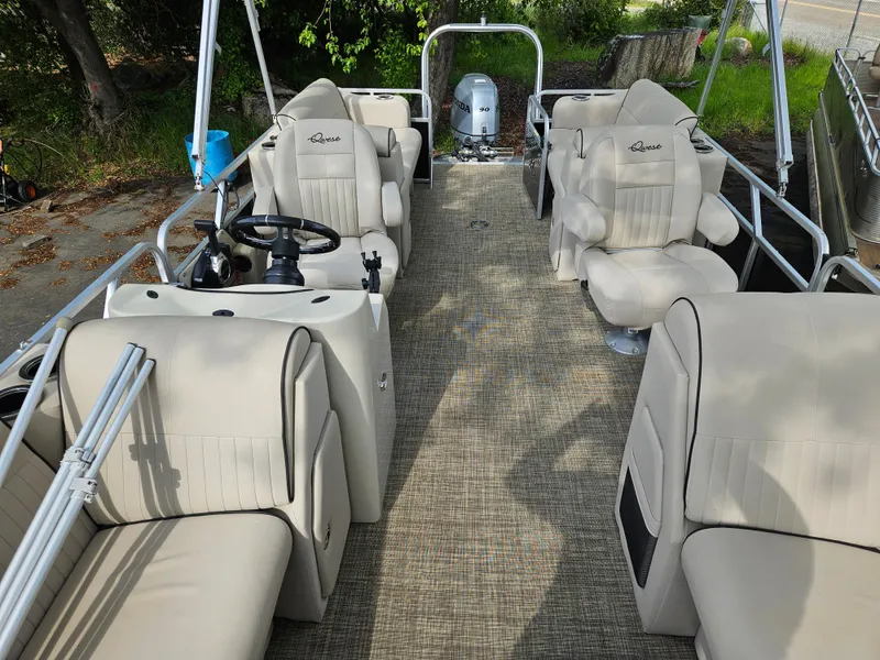 Slide: The Image of 2018 Apex Marine Qwest LS 820 RLS pontoon boat with beige seating and steering console. - 11