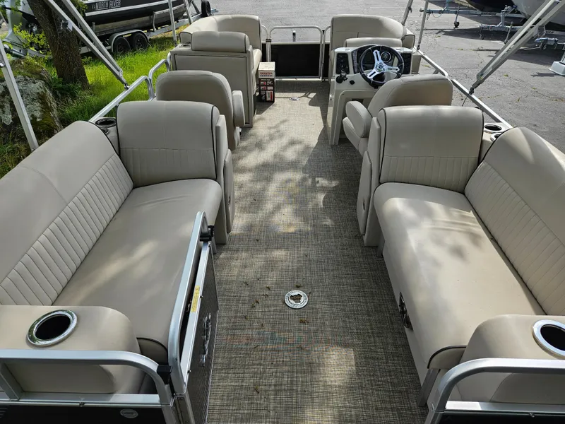 Slide: The Image of 2018 Apex Marine Qwest LS 820 RLS pontoon boat interior with beige seating and steering console. - 12