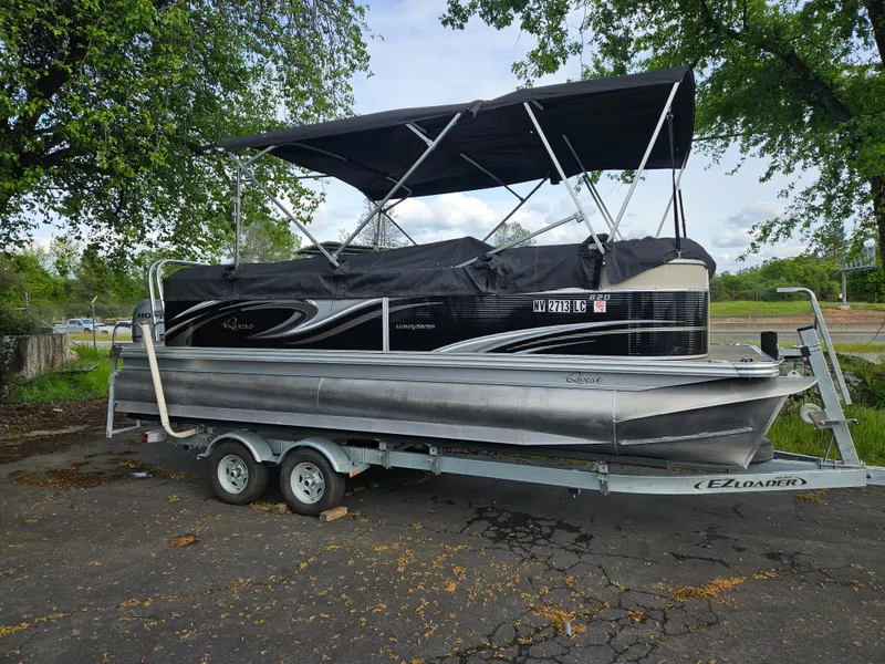 Slide: The Image of 2018 Apex Marine Qwest LS 820 RLS pontoon boat on trailer, parked outdoors. - 2