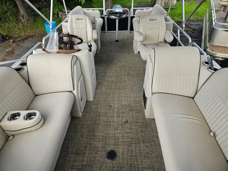 Slide: The Image of 2018 Apex Marine Qwest LS 820 RLS pontoon boat with beige seating and spacious interior. - 3