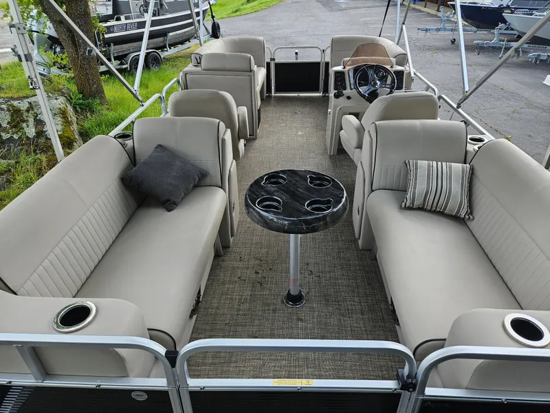 Slide: The Image of 2018 Apex Marine Qwest LS 820 RLS pontoon boat with beige seating and central table. - 4