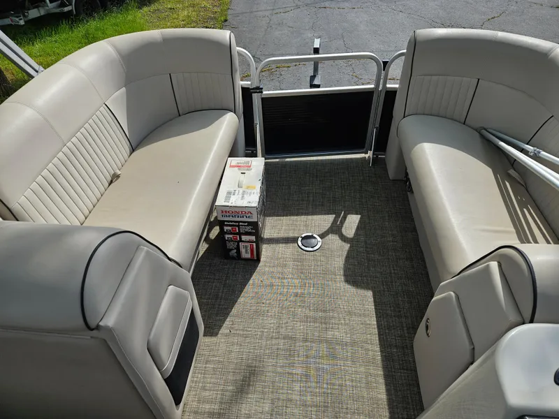Slide: The Image of 2018 Apex Marine Qwest LS 820 RLS pontoon boat interior with beige seating and carpeted floor. - 9