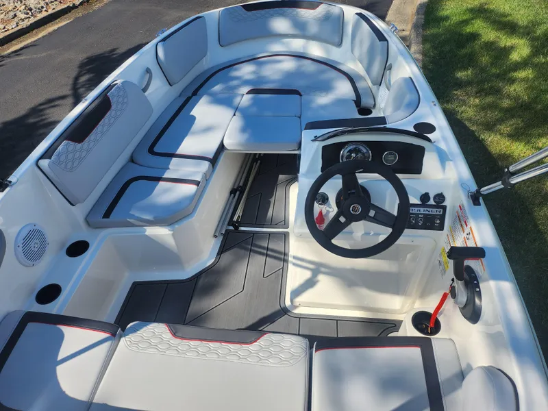 Slide: The Image of 2023 Bayliner Element M15 boat interior with seating and steering console. - 11