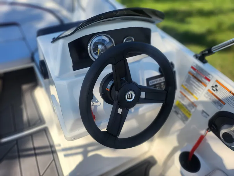 Slide: The Image of 2023 Bayliner Element M15 steering wheel and dashboard close-up. - 13