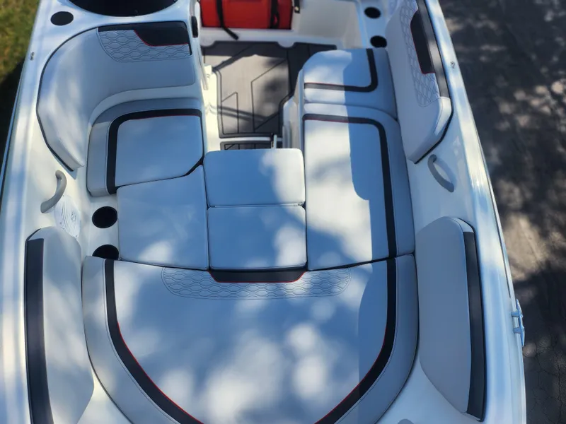 Slide: The Image of 2023 Bayliner Element M15 boat interior with cushioned seating and modern design. - 15