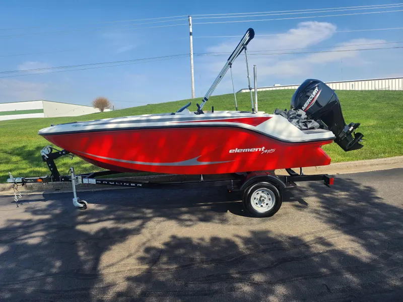 Slide: The Image of 2023 Bayliner Element M15 boat in red on a trailer, parked outdoors. - 4
