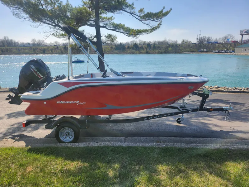 Slide: The Image of 2023 Bayliner Element M15 boat on trailer by a lake. - 9