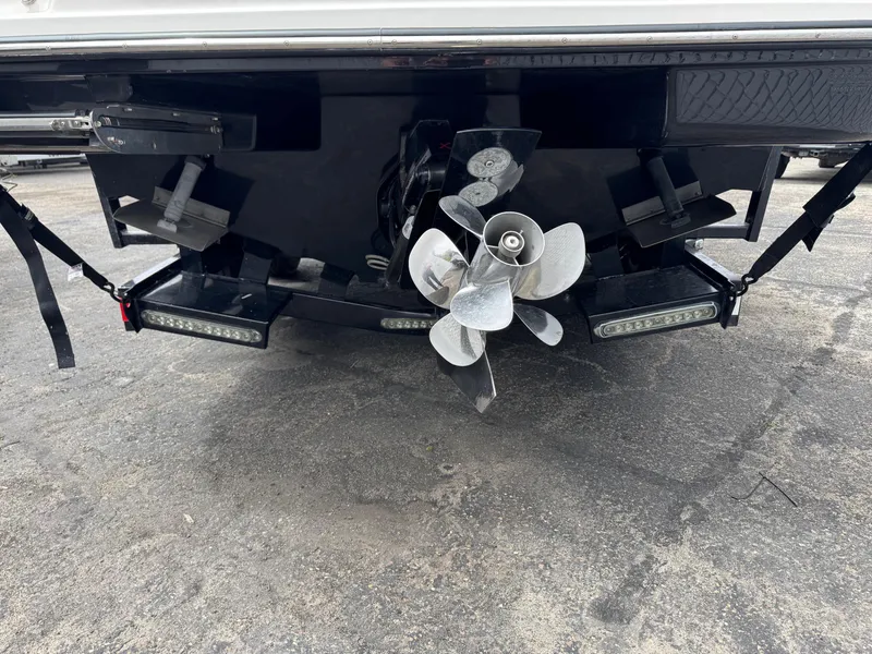 Slide: The Image of Rear view of 2012 Sea Ray 250 SLX boat showing propeller and trim tabs. - 11