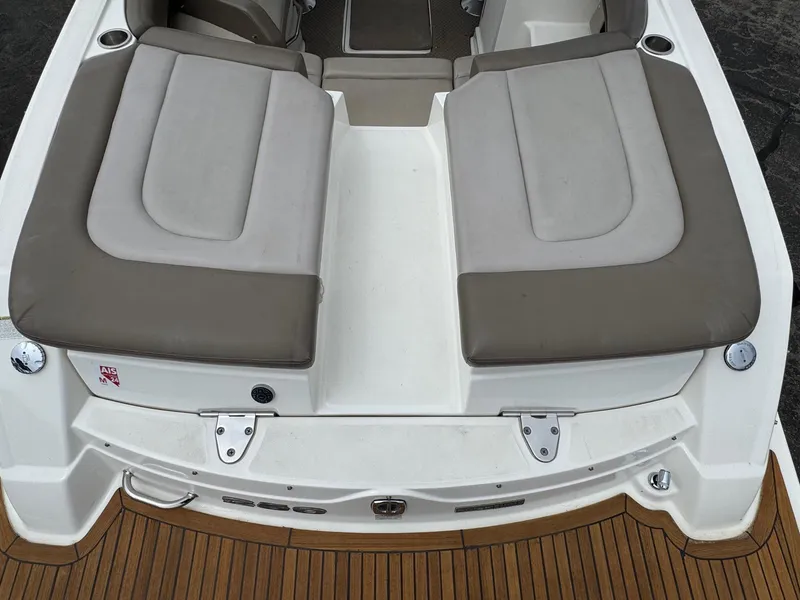 Slide: The Image of 2012 Sea Ray 250 SLX boat with cushioned seating and teak deck. - 15