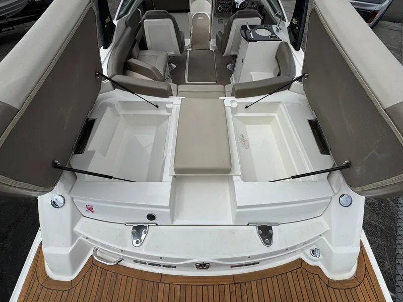 Slide: The Image of 2012 Sea Ray 250 SLX boat interior with open storage compartments and seating. - 16