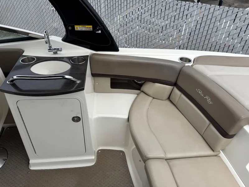 Slide: The Image of 2012 Sea Ray 250 SLX boat interior with seating and sink area. - 20
