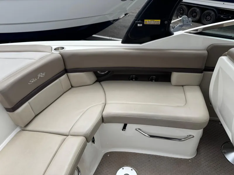 Slide: The Image of 2012 Sea Ray 250 SLX boat interior with beige seating and sleek design. - 21