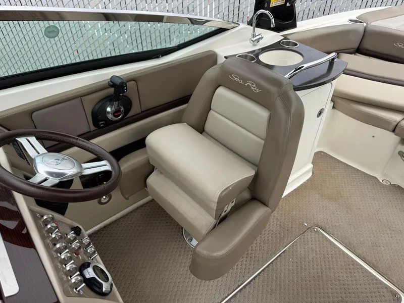Slide: The Image of Interior of 2012 Sea Ray 250 SLX boat with steering wheel and seating. - 23