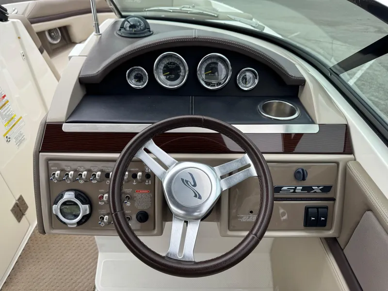 Slide: The Image of 2012 Sea Ray 250 SLX dashboard with steering wheel and instrument panel. - 25