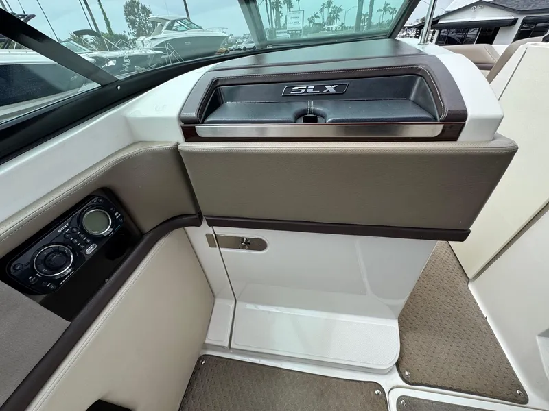 Slide: The Image of Interior view of a 2012 Sea Ray 250 SLX boat dashboard and seating area. - 26