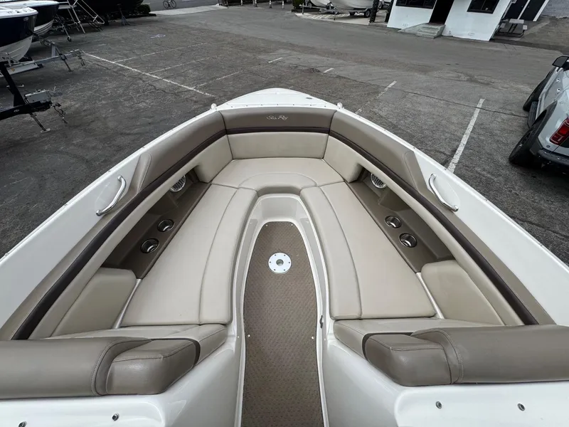 Slide: The Image of 2012 Sea Ray 250 SLX boat interior with beige seating and cup holders. - 30