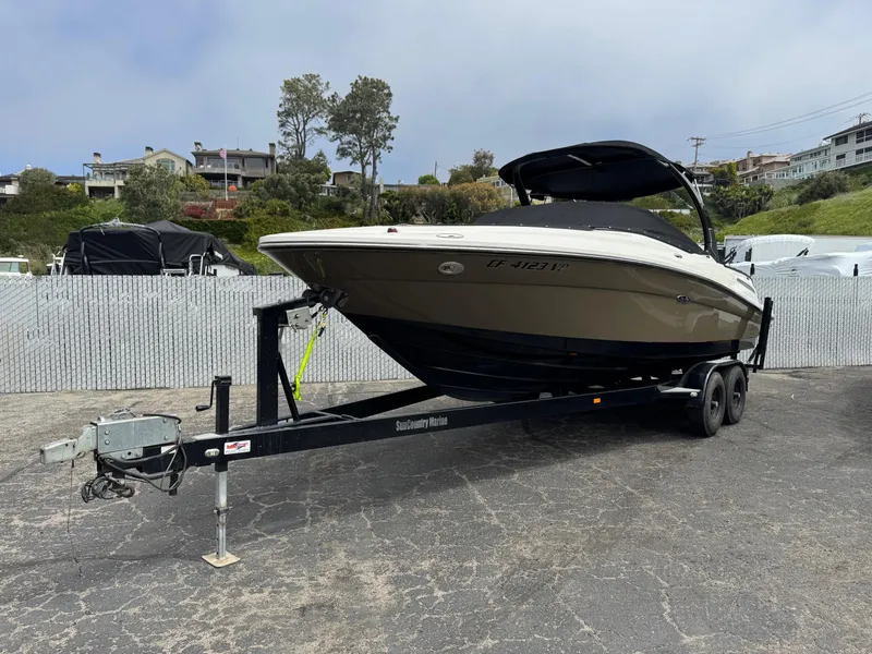 Slide: The Image of 2012 Sea Ray 250 SLX boat on trailer, parked outdoors. - 7