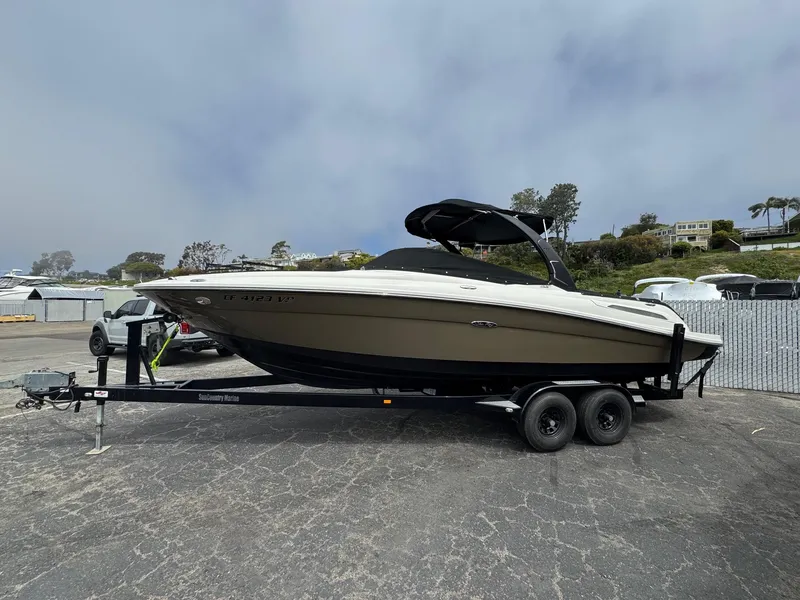 Slide: The Image of 2012 Sea Ray 250 SLX boat on trailer in parking lot. - 8
