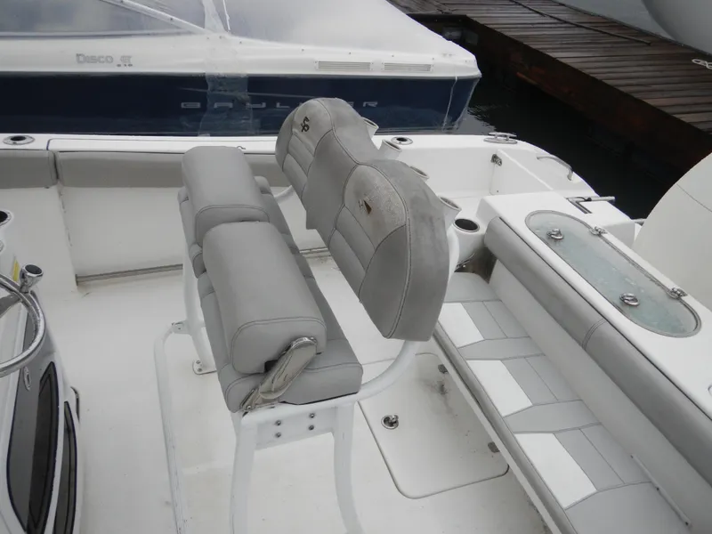 Slide: The Image of 2018 Sea Pro 219 Center Console boat interior with cushioned seating and storage compartments. - 11