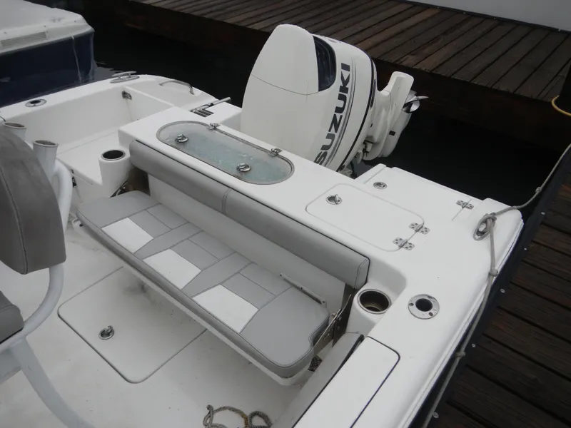 Slide: The Image of 2018 Sea Pro 219 Center Console boat with Suzuki outboard motor, docked at a wooden pier. - 12