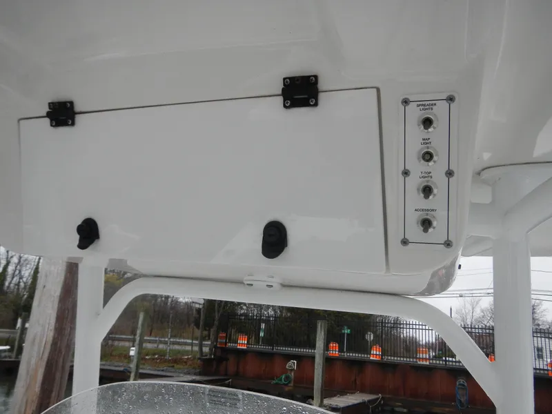 Slide: The Image of 2018 Sea Pro 219 Center Console boat dashboard with control panel and storage compartment. - 13