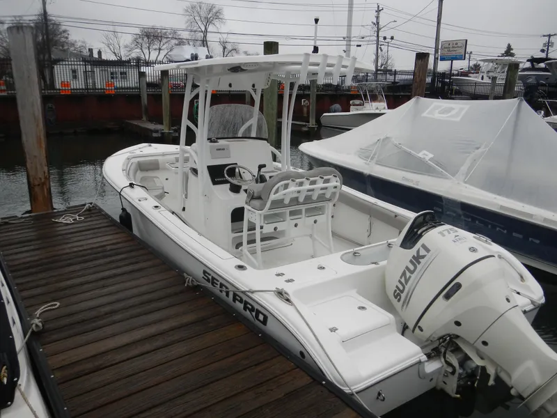 Slide: The Image of 2018 Sea Pro 219 Center Console boat docked with Suzuki outboard motor. - 2