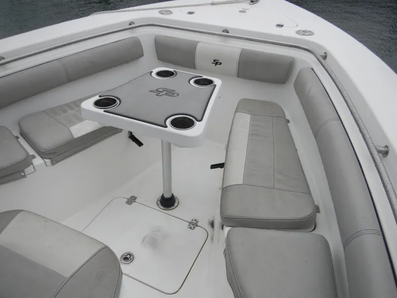 Slide: The Image of 2018 Sea Pro 219 Center Console boat interior with cushioned seating and table. - 4