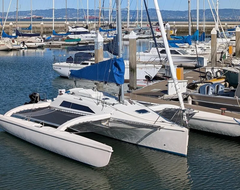 The Image of Sailboats docked at marina, featuring a 1996 Corsair F-31 trimaran in the foreground. - 0