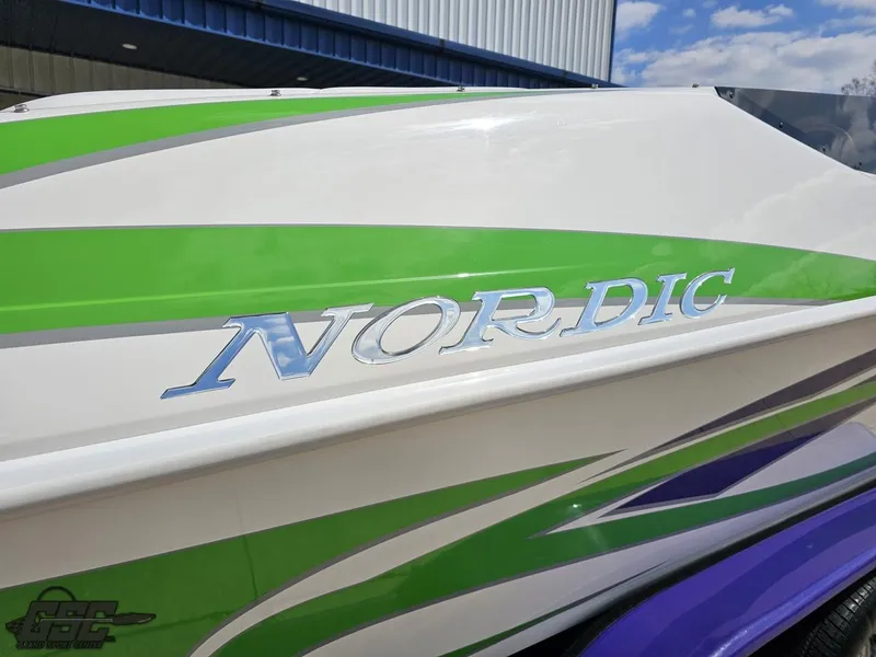 Slide: The Image of 2007 Nordic 28 Heat MCOB boat with green and purple accents. - 13
