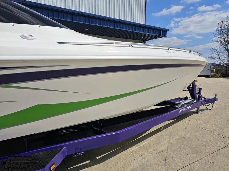 Slide: The Image of 2007 Nordic 28 Heat MCOB boat on purple trailer, white with green accents. - 15