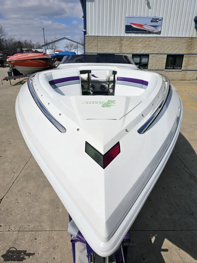 Slide: The Image of 2007 Nordic 28 Heat MCOB boat, white hull, parked outdoors near a building. - 19