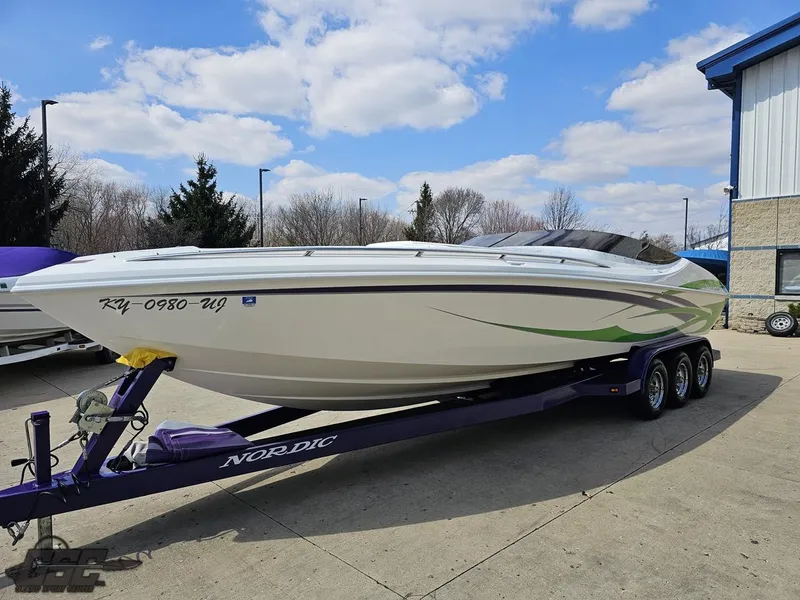 Slide: The Image of 2007 Nordic 28 Heat MCOB boat on trailer, parked outdoors under a partly cloudy sky. - 22