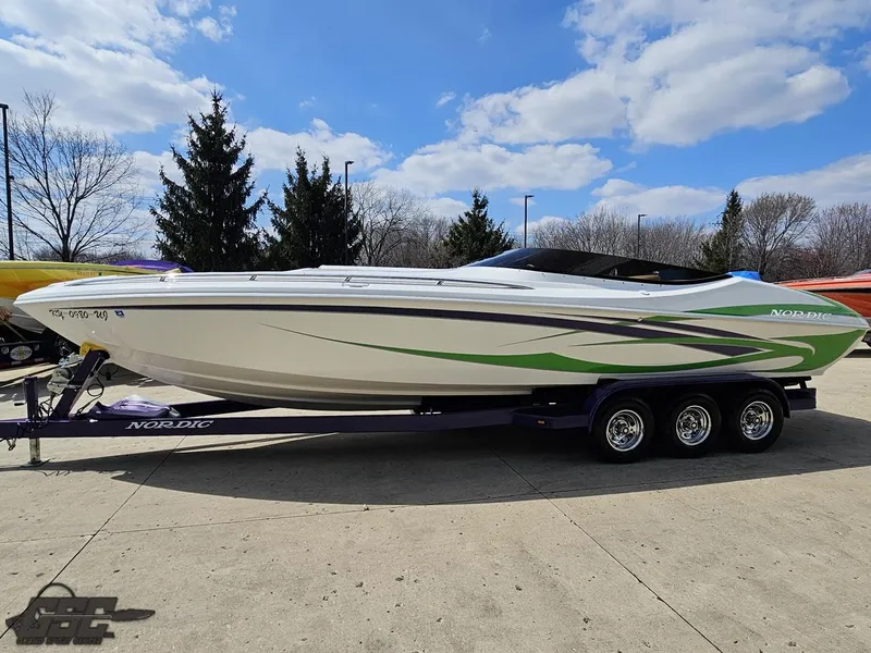 Slide: The Image of Nordic 28 Heat MCOB 2007 speedboat on trailer, white with green accents, parked outdoors. - 23