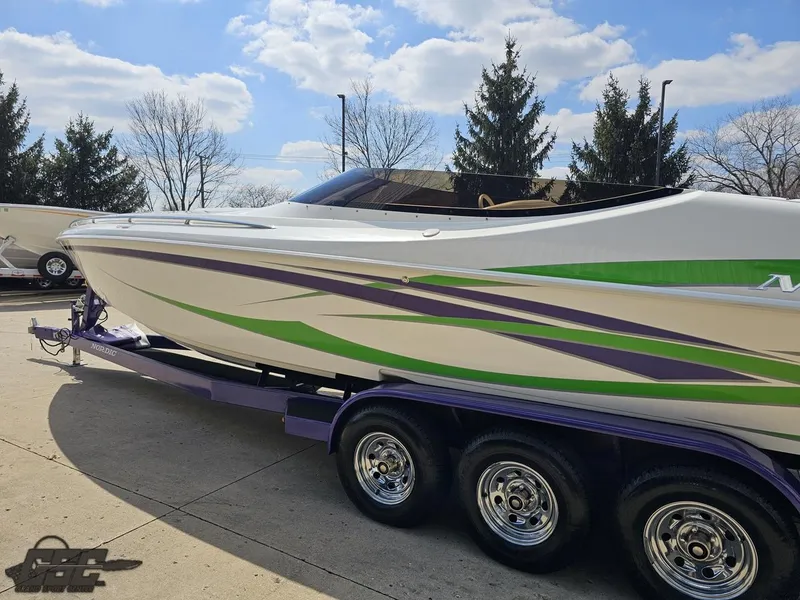 Slide: The Image of 2007 Nordic 28 Heat MCOB boat on trailer, featuring green and purple accents. - 29