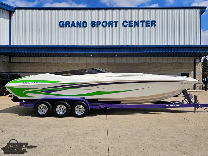 Slide: The Image of 2007 Nordic 28 Heat MCOB boat with green accents at Grand Sport Center. - 3