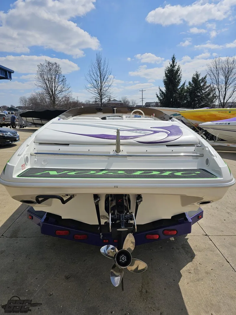 Slide: The Image of 2007 Nordic 28 Heat MCOB boat, rear view, parked outdoors under a blue sky. - 34