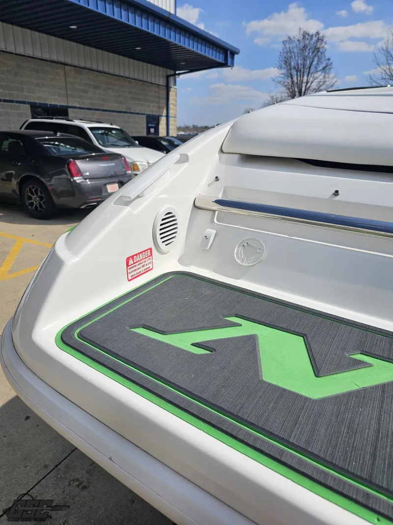 Slide: The Image of 2007 Nordic 28 Heat MCOB boat rear view with logo, parked outdoors. - 37