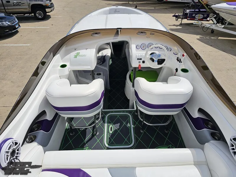 Slide: The Image of Interior of a 2007 Nordic 28 Heat MCOB boat with white and purple seating. - 42
