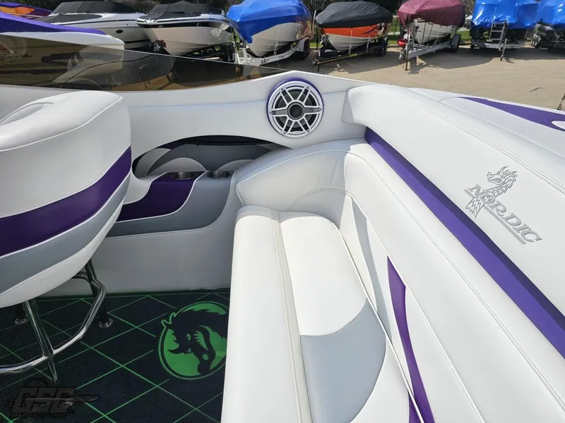 Slide: The Image of Interior of a 2007 Nordic 28 Heat MCOB boat with white and purple seating. - 47