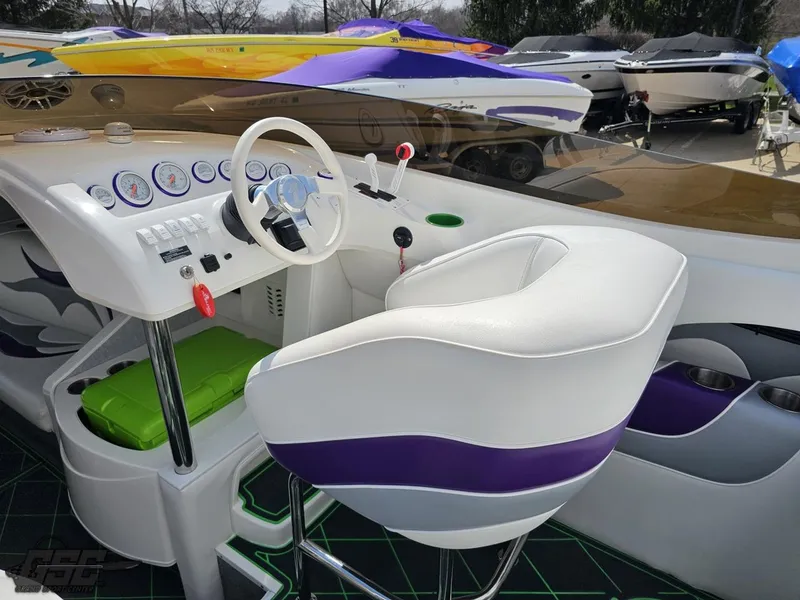 Slide: The Image of Cockpit of 2007 Nordic 28 Heat MCOB boat with white and purple seating. - 48