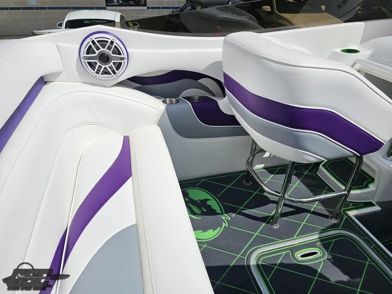Slide: The Image of Interior of a 2007 Nordic 28 Heat MCOB boat with white and purple seating. - 49